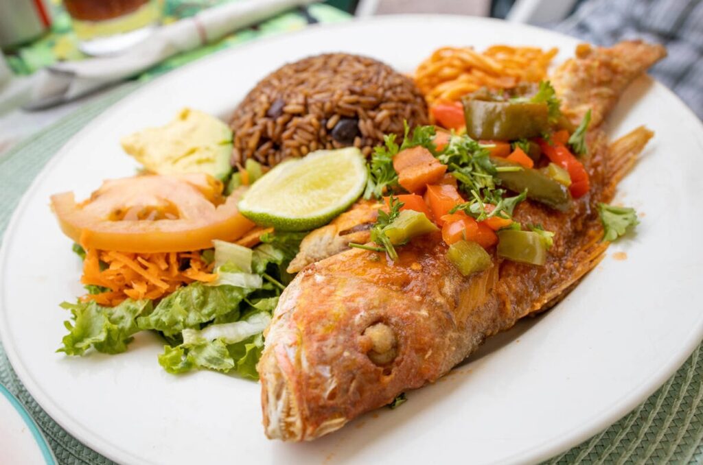 Caribbean dishes served at a beachfront table on the St. Maarten Boardwalk