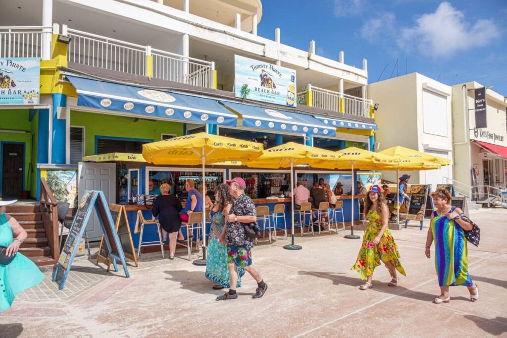 Outdoor restaurant seating along the St Maarten Boardwalk with views of Great Bay