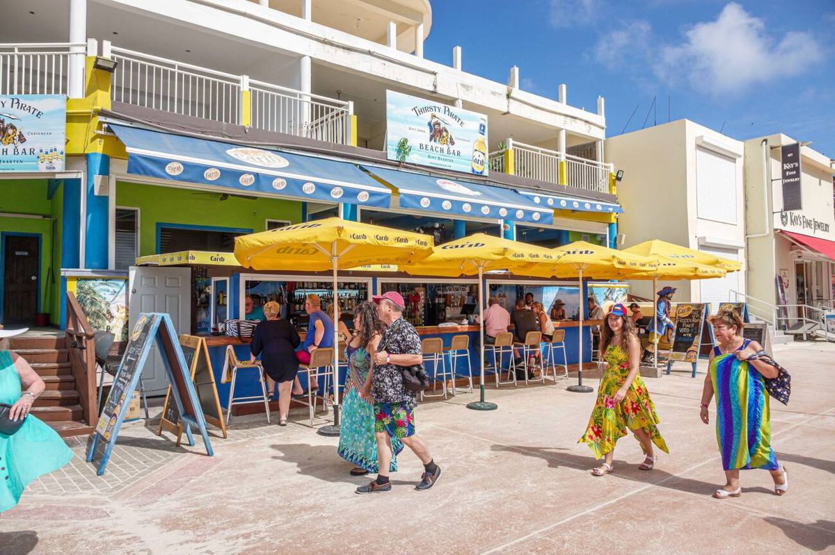 Outdoor restaurant seating along the St Maarten Boardwalk with views of Great Bay