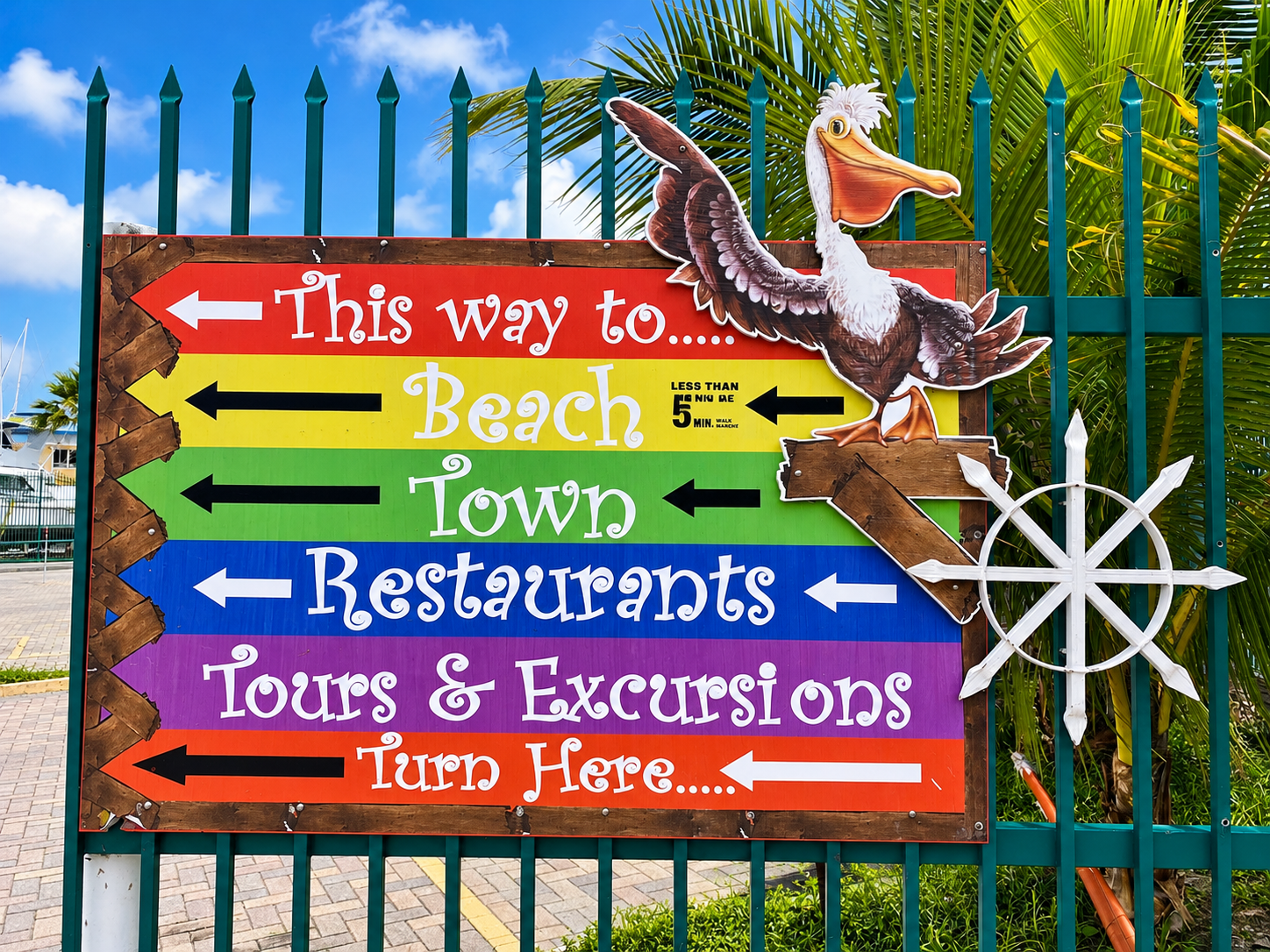 Colorful directional sign pointing toward the beach, town and restaurants in St. Maarten